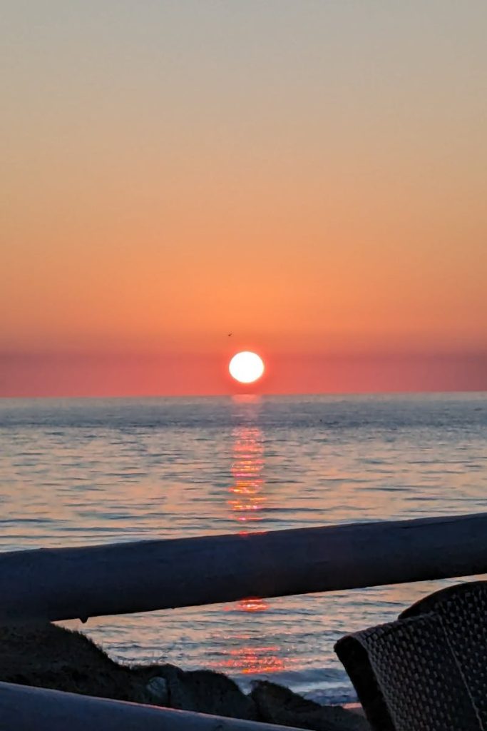 Captivating sunset over the Mediterranean Sea in Málaga, Spain, showcasing vibrant orange hues.