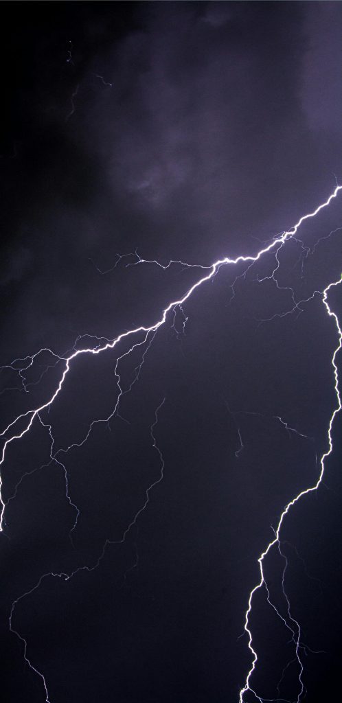 Captivating lightning bolts illuminate the dark night sky.